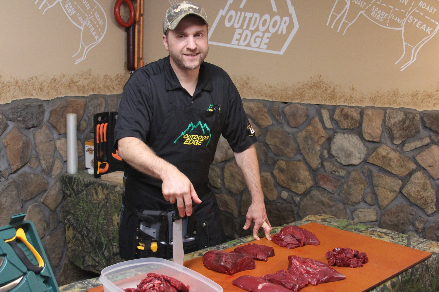 A hunter field dressing an elk in the mountains using an Outdoor Edge RazorSafe knife