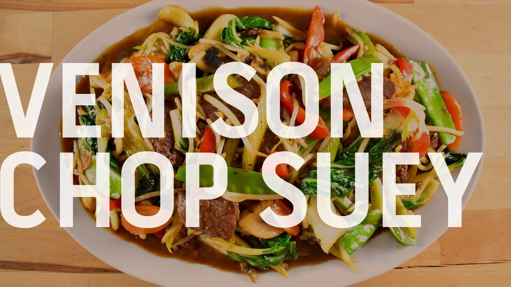 A bowl of venison chop suey filled with meat and vegetables, served over rice