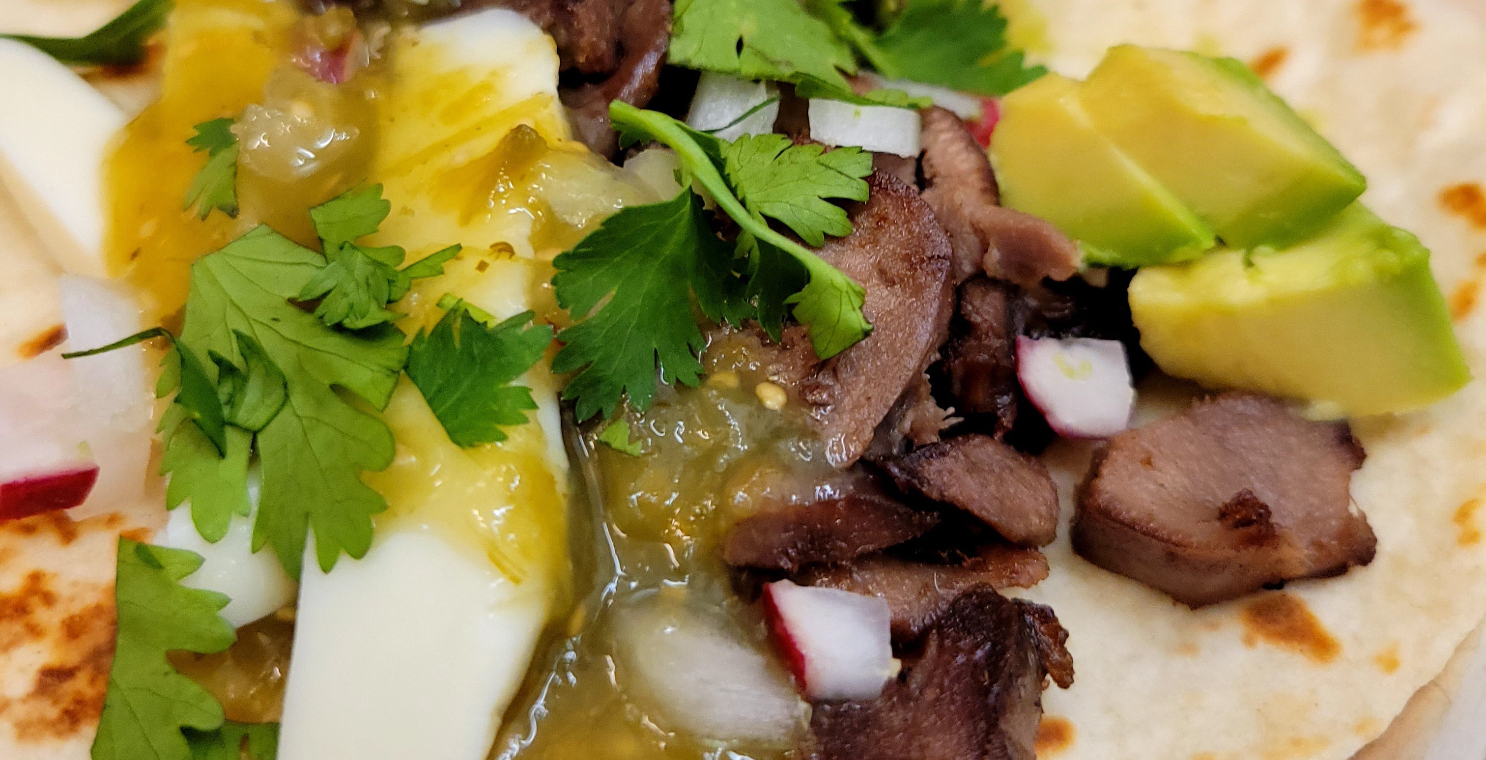 A recipe banner for "Deer Tongue Tacos" showing two finished tacos on a plate