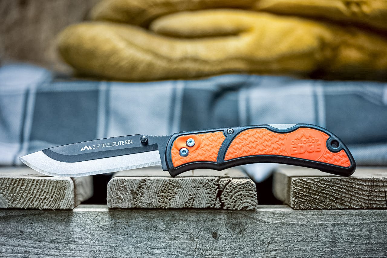 "A close-up of the gray RazorLite EDC knife handle, showing the textured grip and pocket clip."