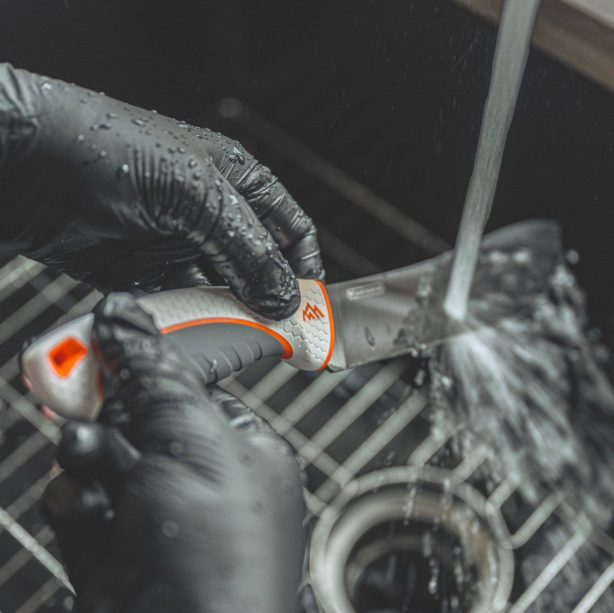 Person using a cleaning a knife in a sink