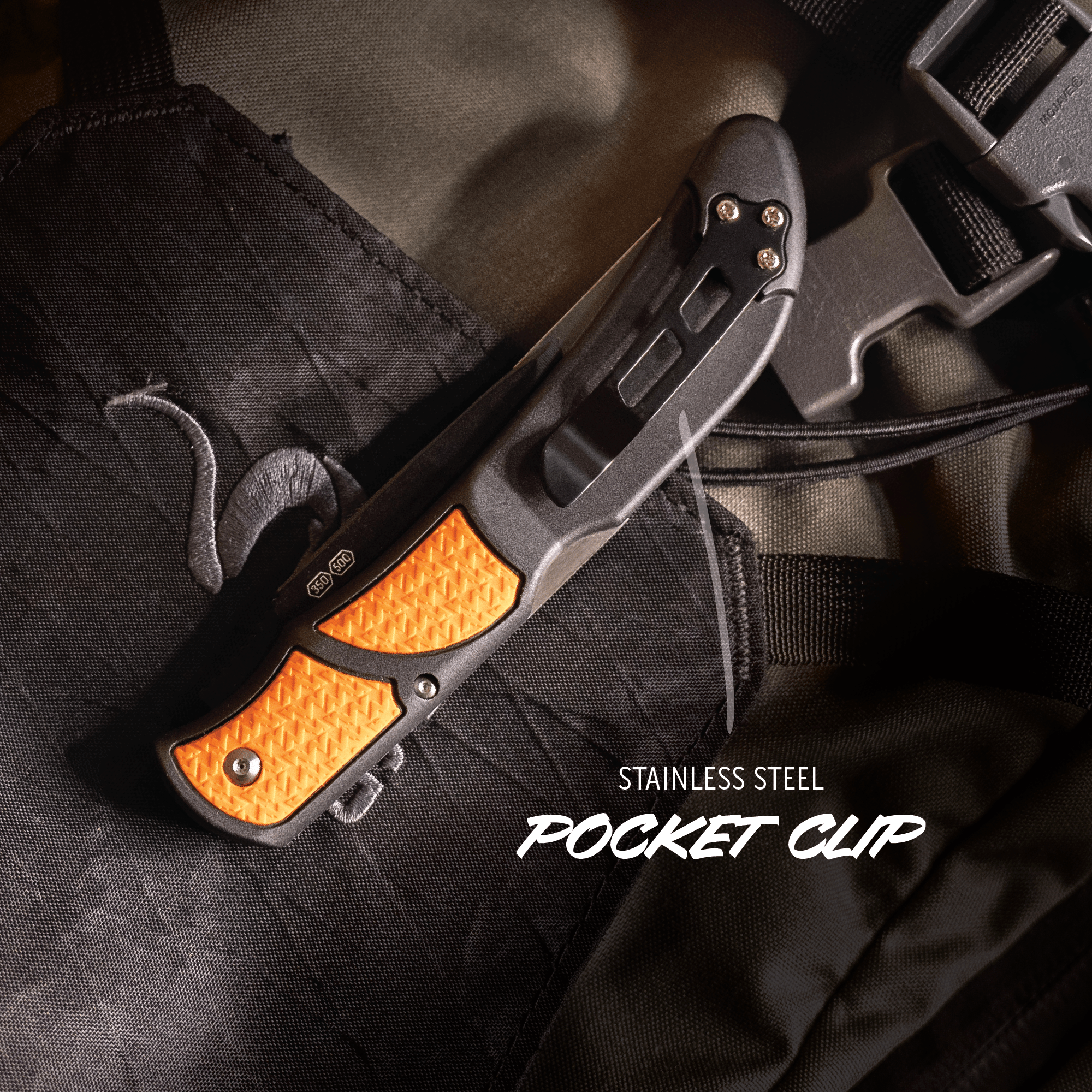 Folding knife with orange handle and black metal blade on a dark fabric background