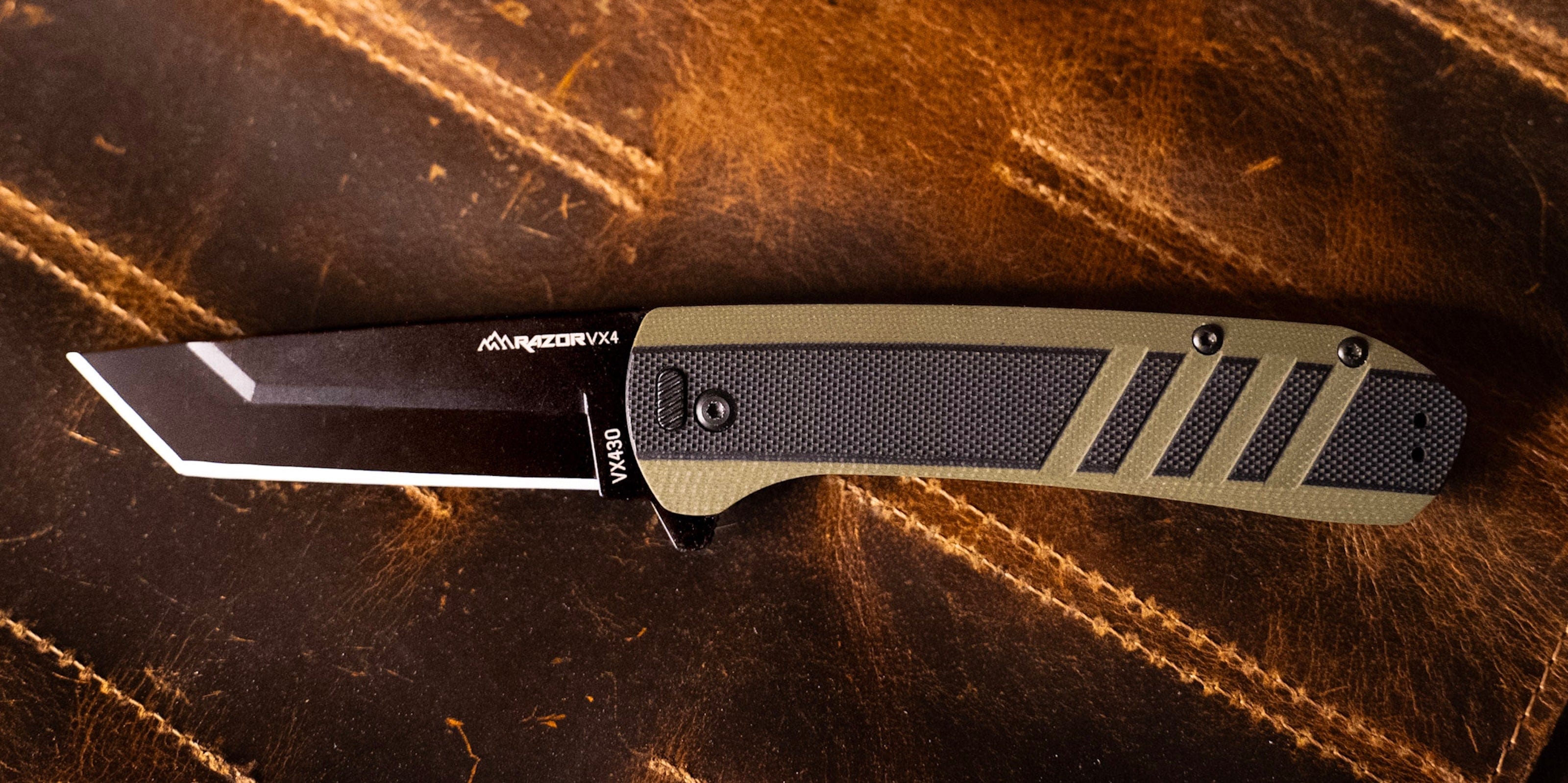 The Razor-VX4 folding knife with a green G10 and carbon fiber handle and cleaver-style blade