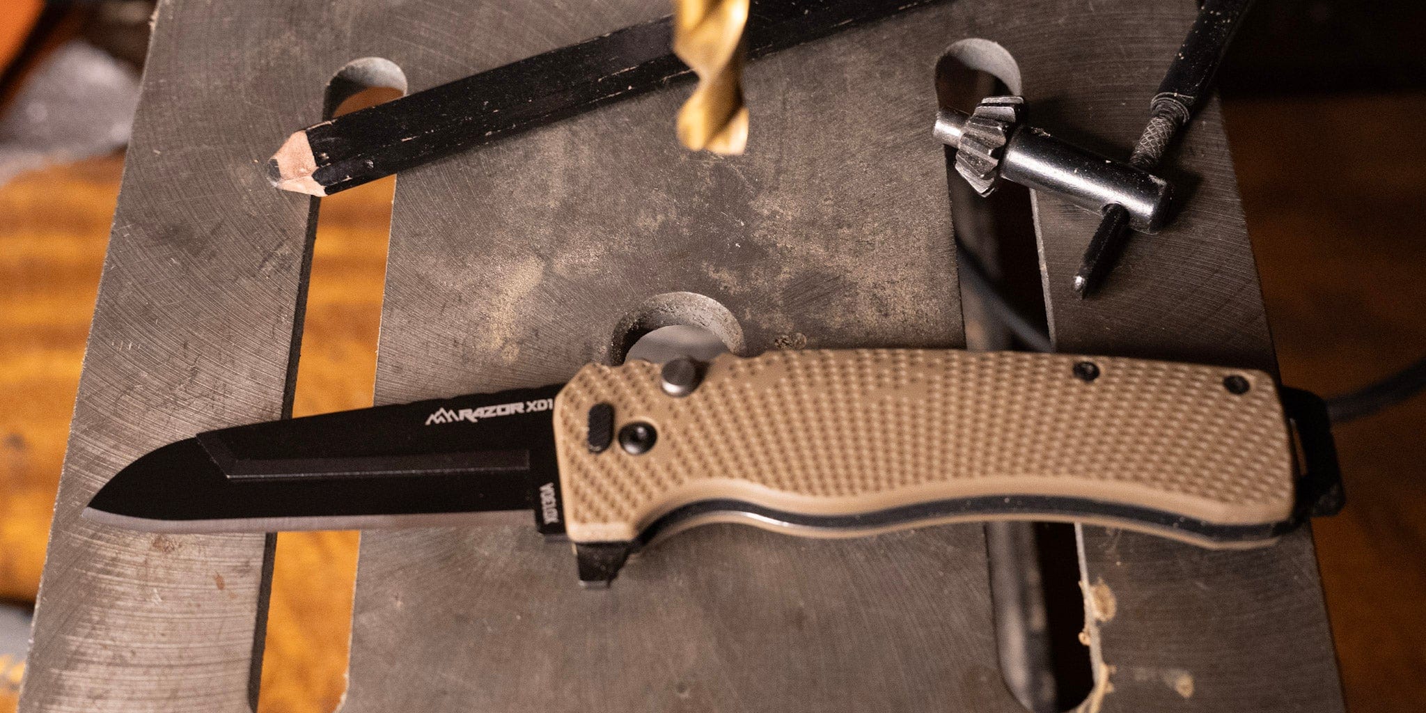 The Razor-XD1 utility knife with a grey handle and partially serrated blade