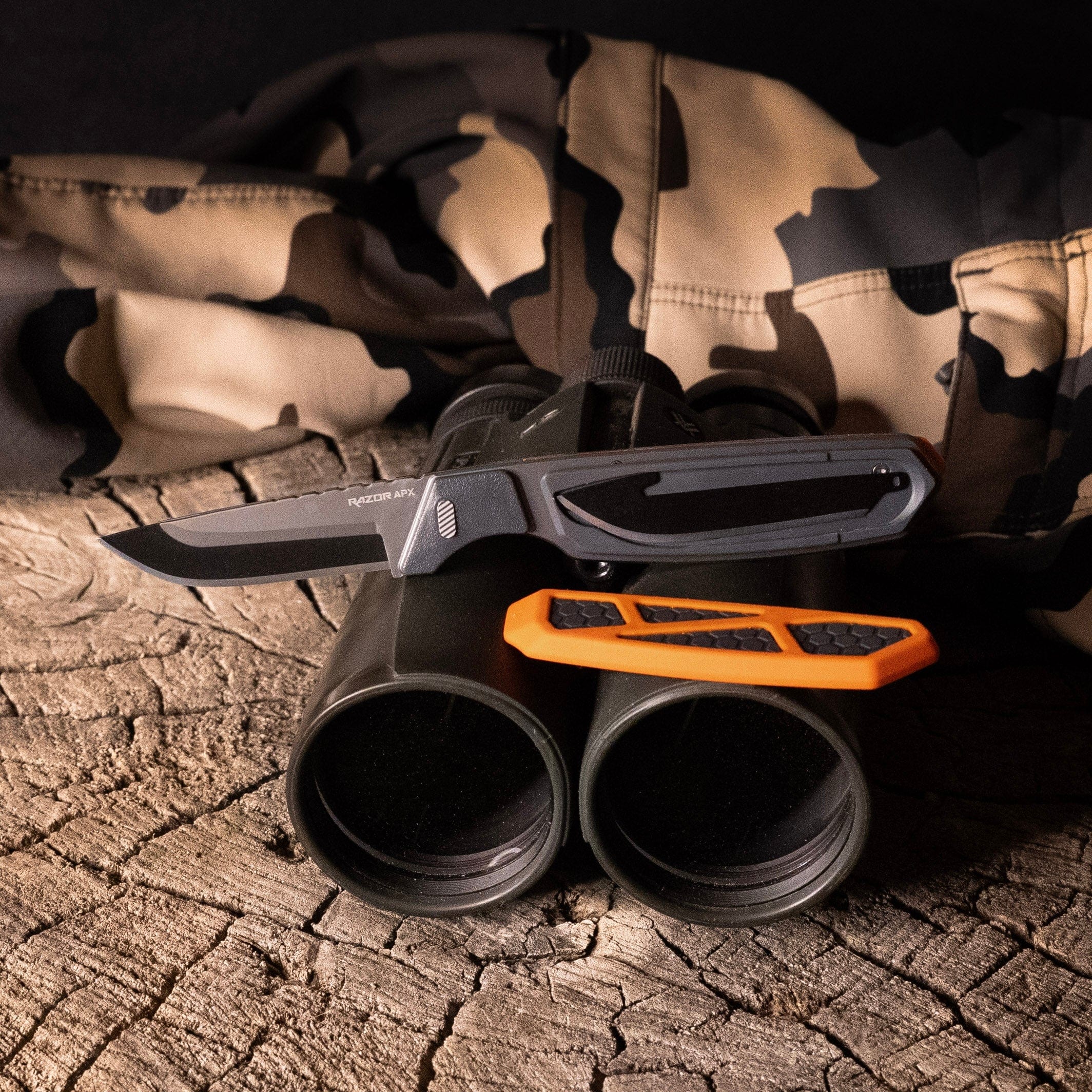 The 2.5-inch Razor-APX knife with a skeletonized orange and grey handle