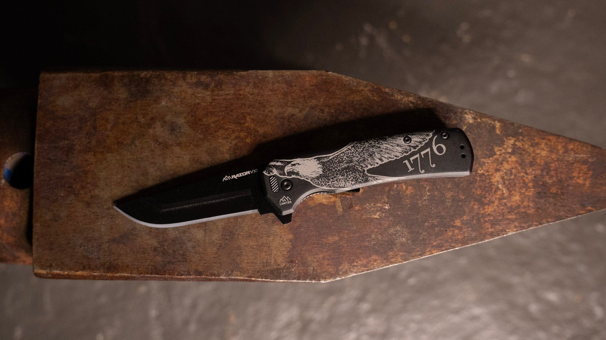 A limited edition Razor-VX5 folding knife with '1776' and a historical flag design on the handle
