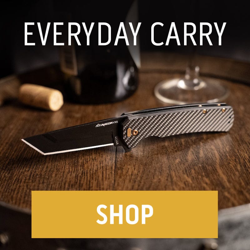 An Outdoor Edge everyday carry knife with a carbon fiber handle and black cleaver-style blade sits on a wooden barrel next to a wine bottle."