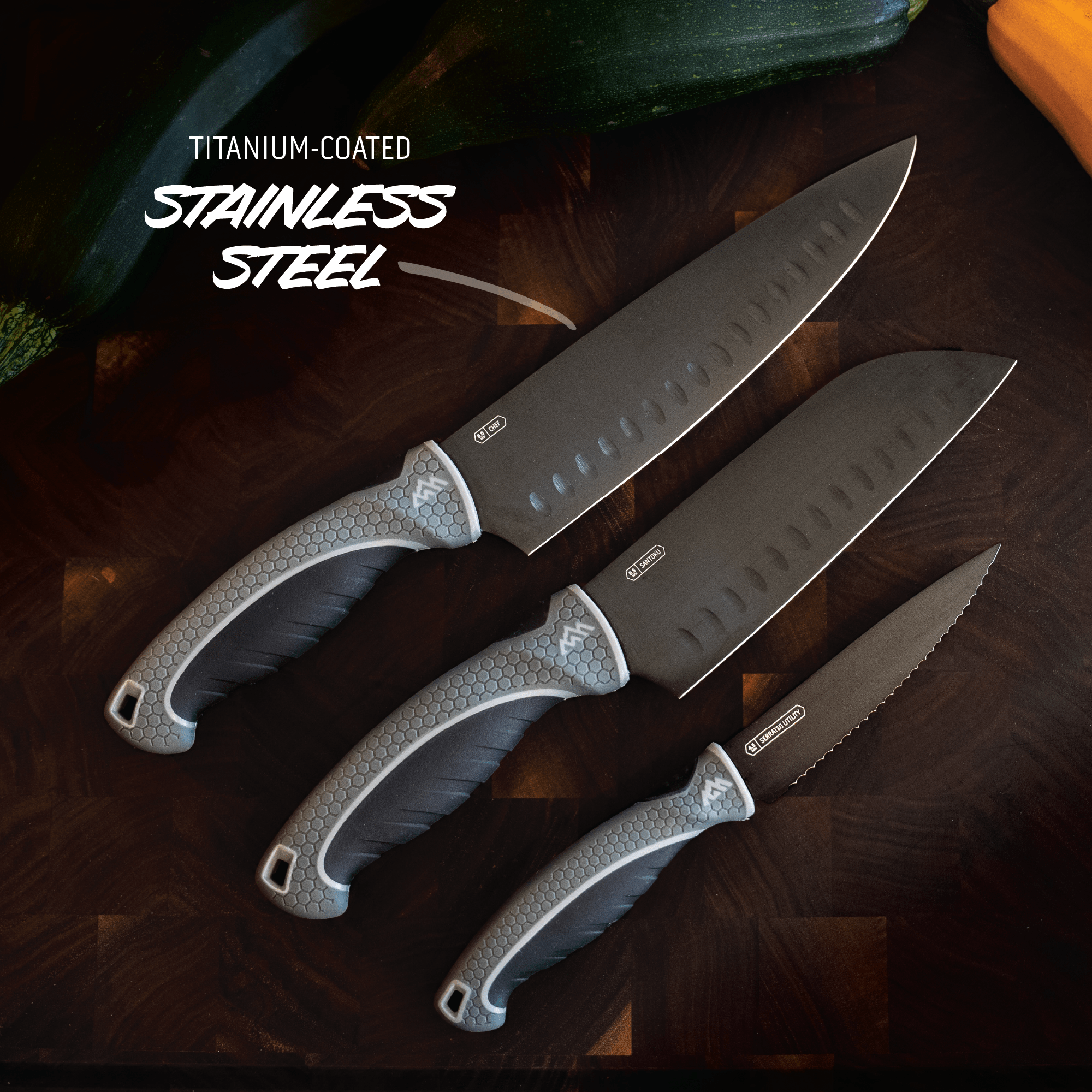 Three knives with titanium-coated stainless steel on a dark surface
