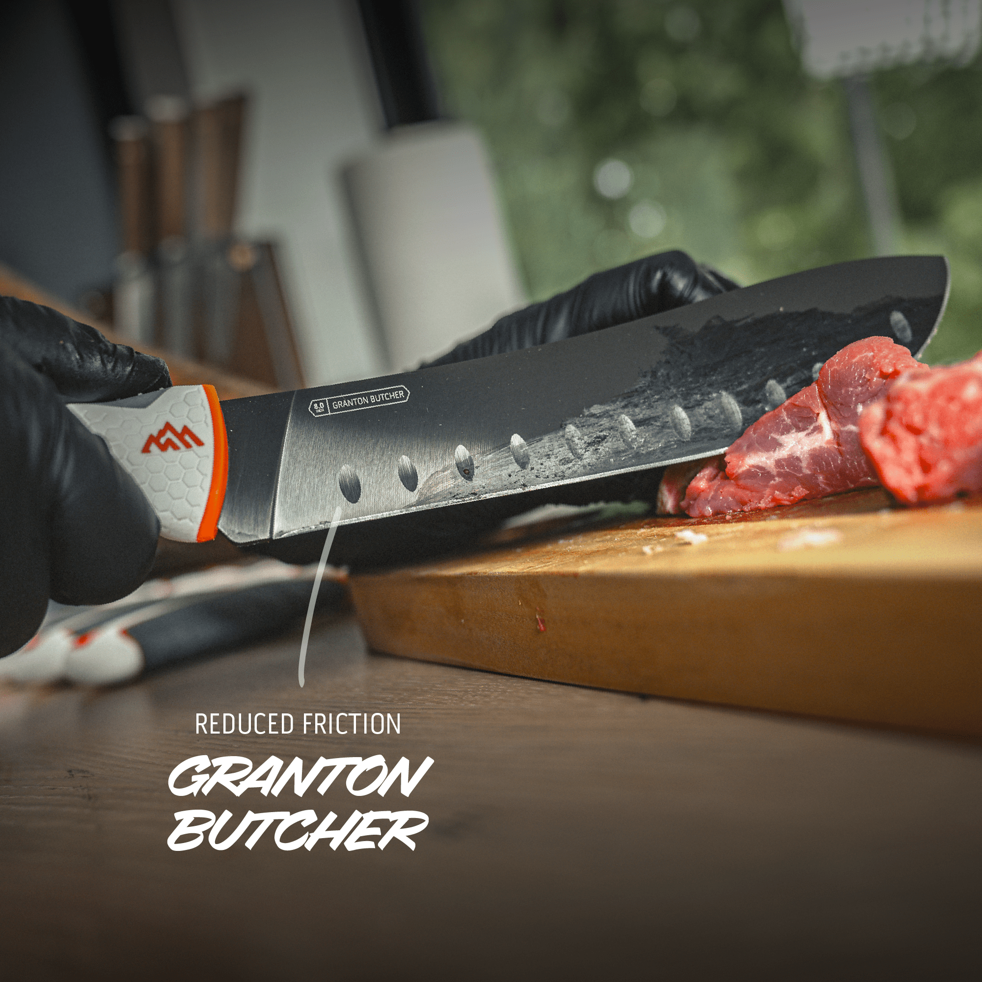 Person cutting meat with a Granton Butcher knife on a wooden cutting board.
