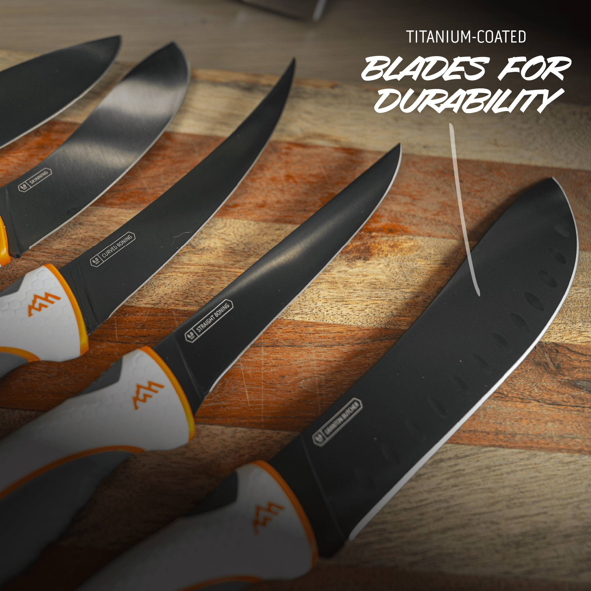 Set of knives with titanium-coated blades on a wooden surface