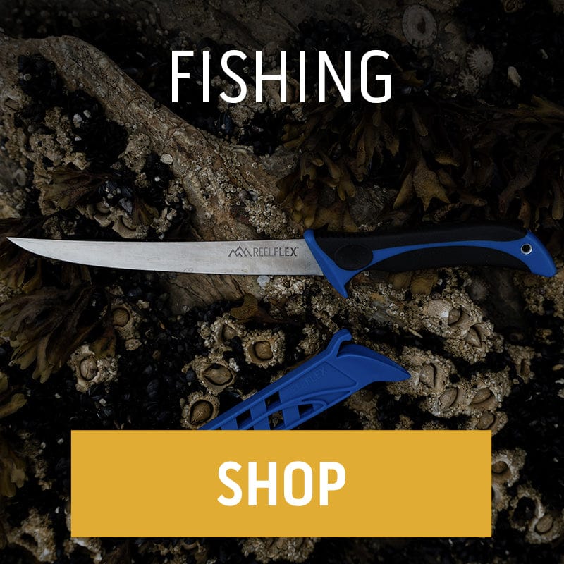 An Outdoor Edge ReelFlex fillet knife with a blue and black handle rests with its blue sheath on a rock covered in barnacles near the water. ",