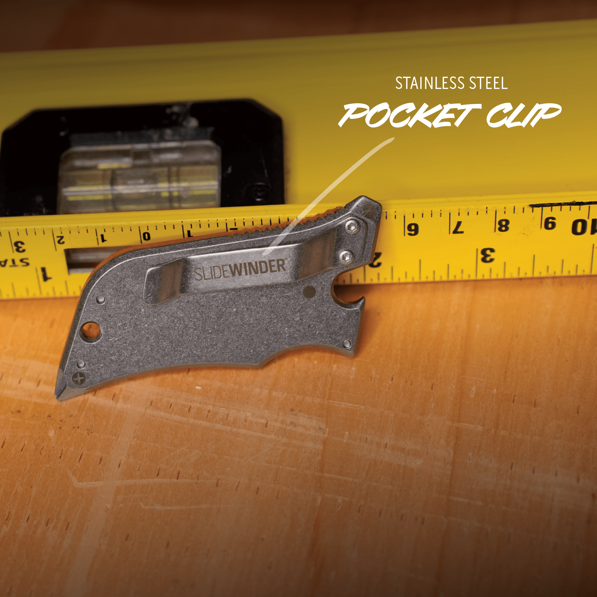 Pocket clip on a wooden surface with a measuring tape for scale, branded 'SlideWinder'.
