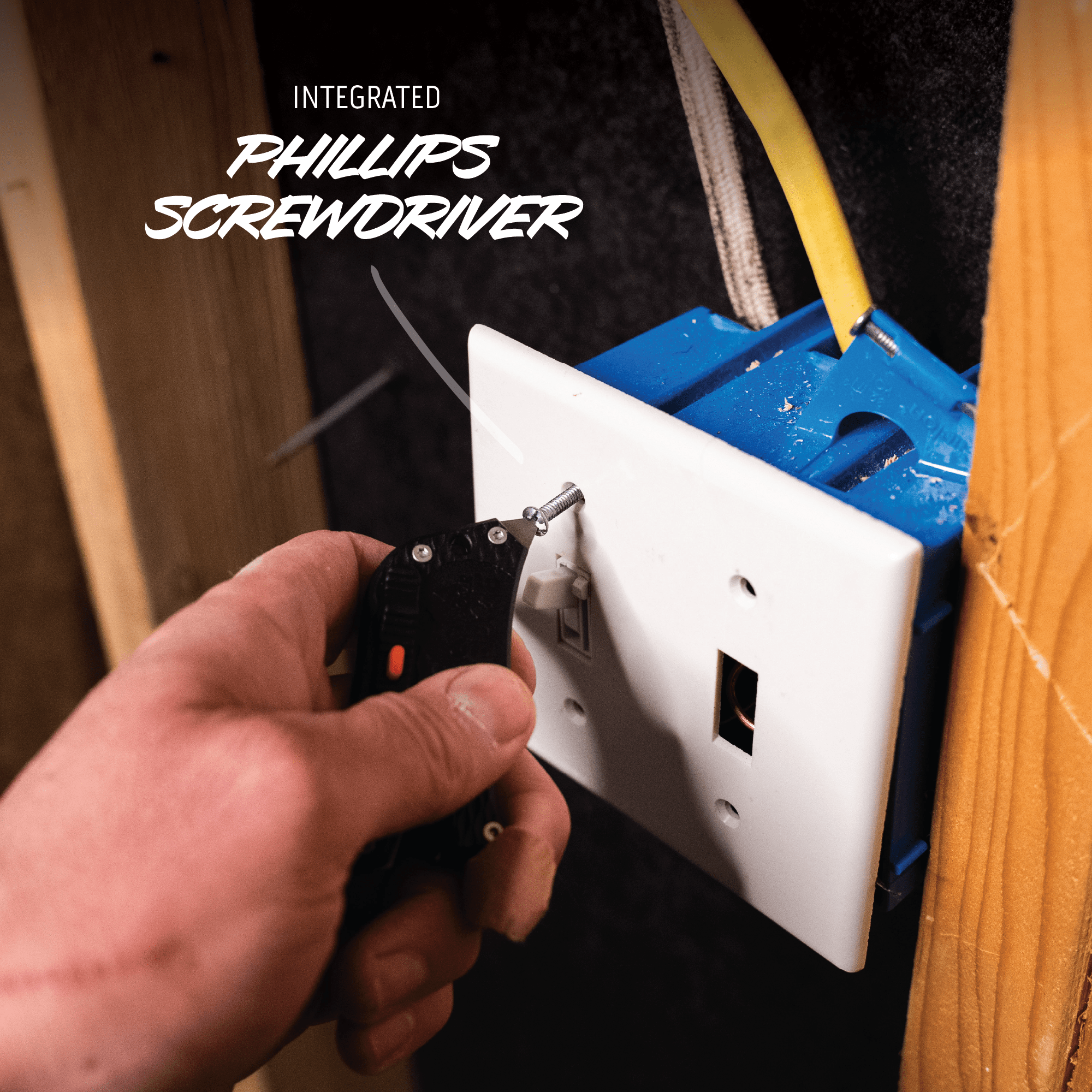 Hand using a screwdriver to work on an electrical outlet with text 'Integrated Phillips Screwdriver'.