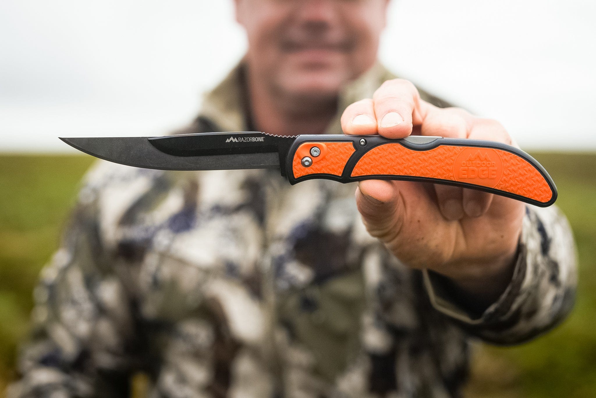 The complete RazorGuide Pak, showing a folding knife and fixed-blade knife with orange handles in a canvas sheath