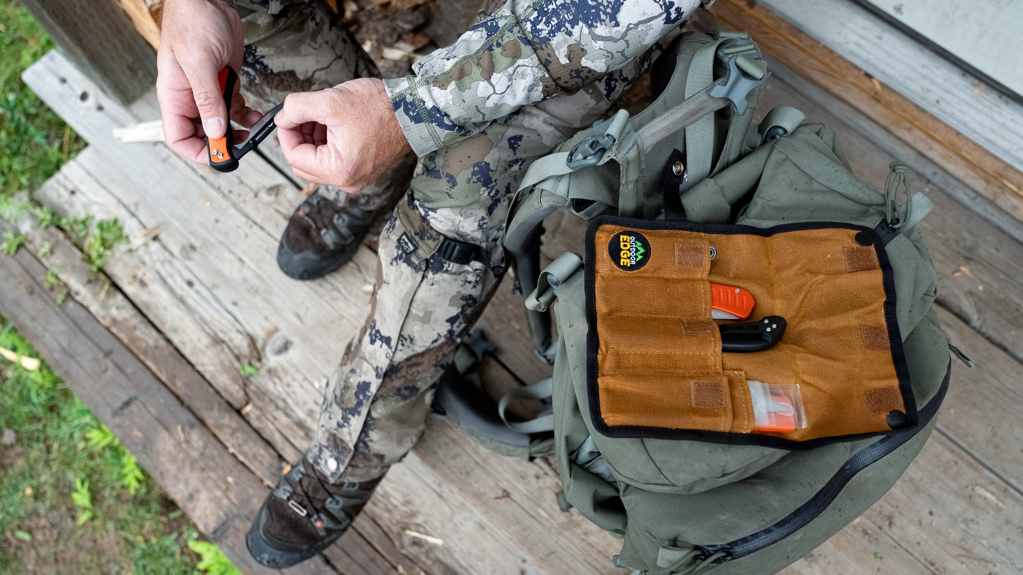 The complete RazorGuide Pak, showing a folding knife and fixed-blade knife with orange handles in a canvas sheath