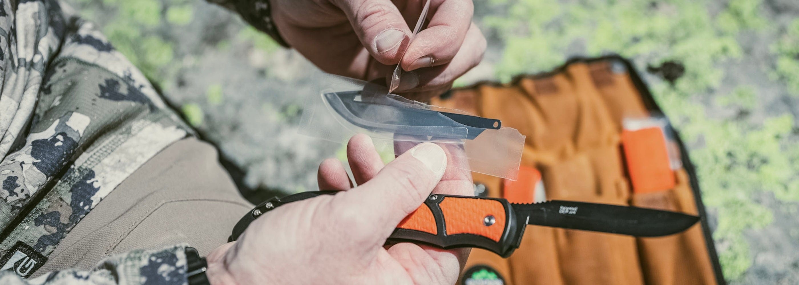 Person holding a folding knife with a blurred background