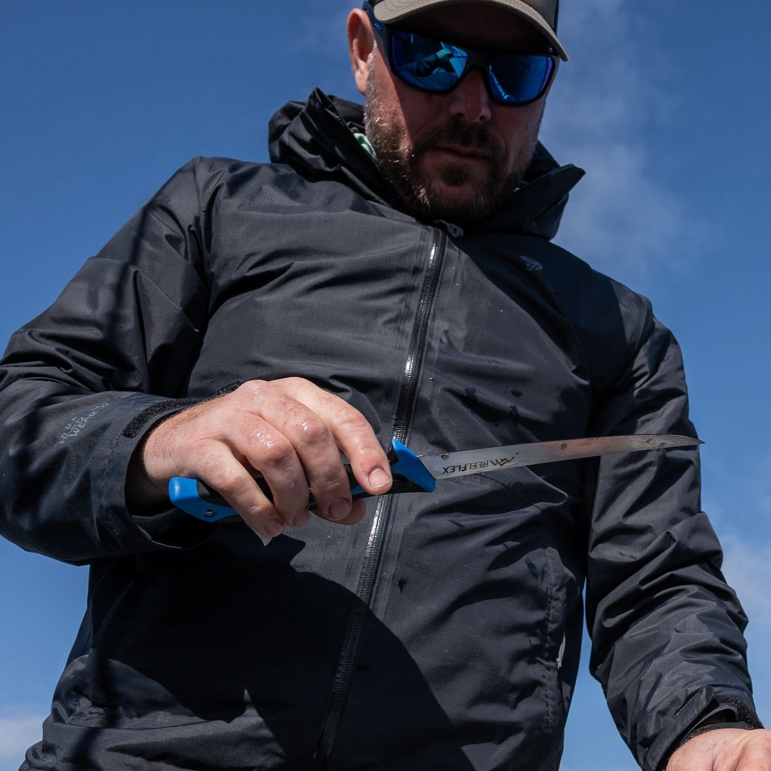 The three fillet knives from the Outdoor Edge ReelFlex Pak shown in their hard-side carry case with a sharpener