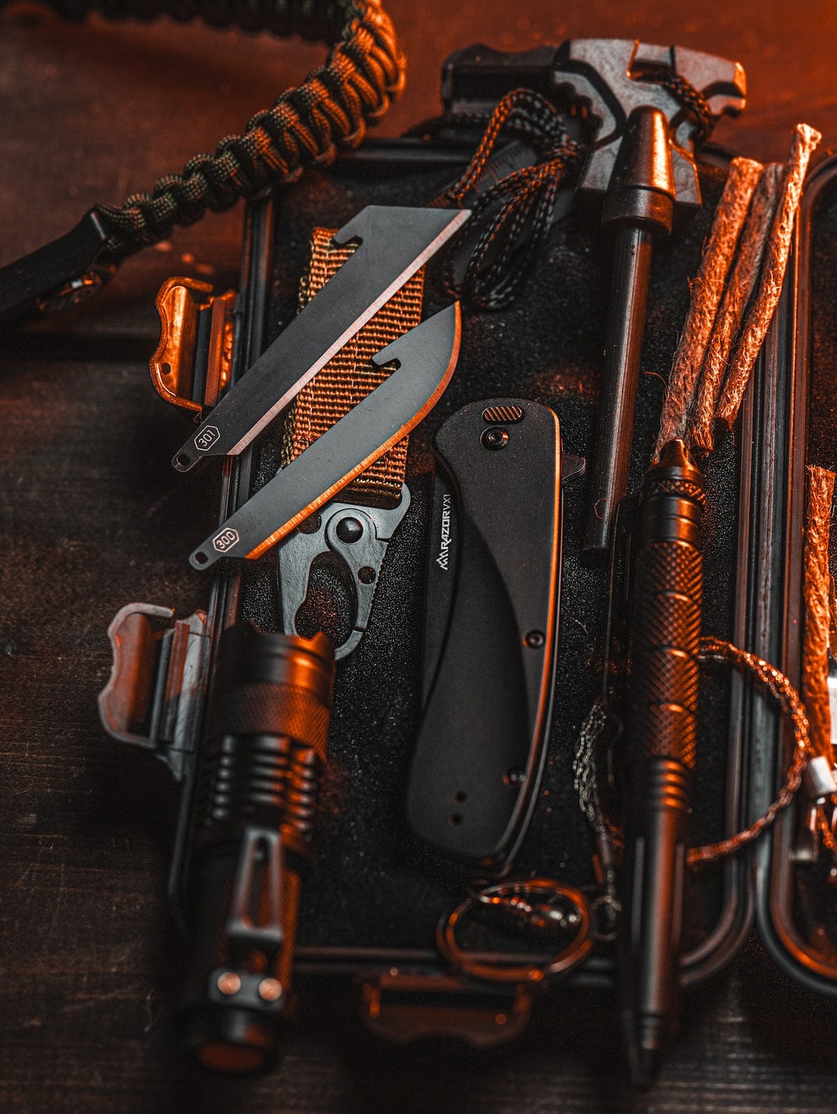 "An overhead shot of an organized survival kit, including an Outdoor Edge RazorSafe knife and other tools."