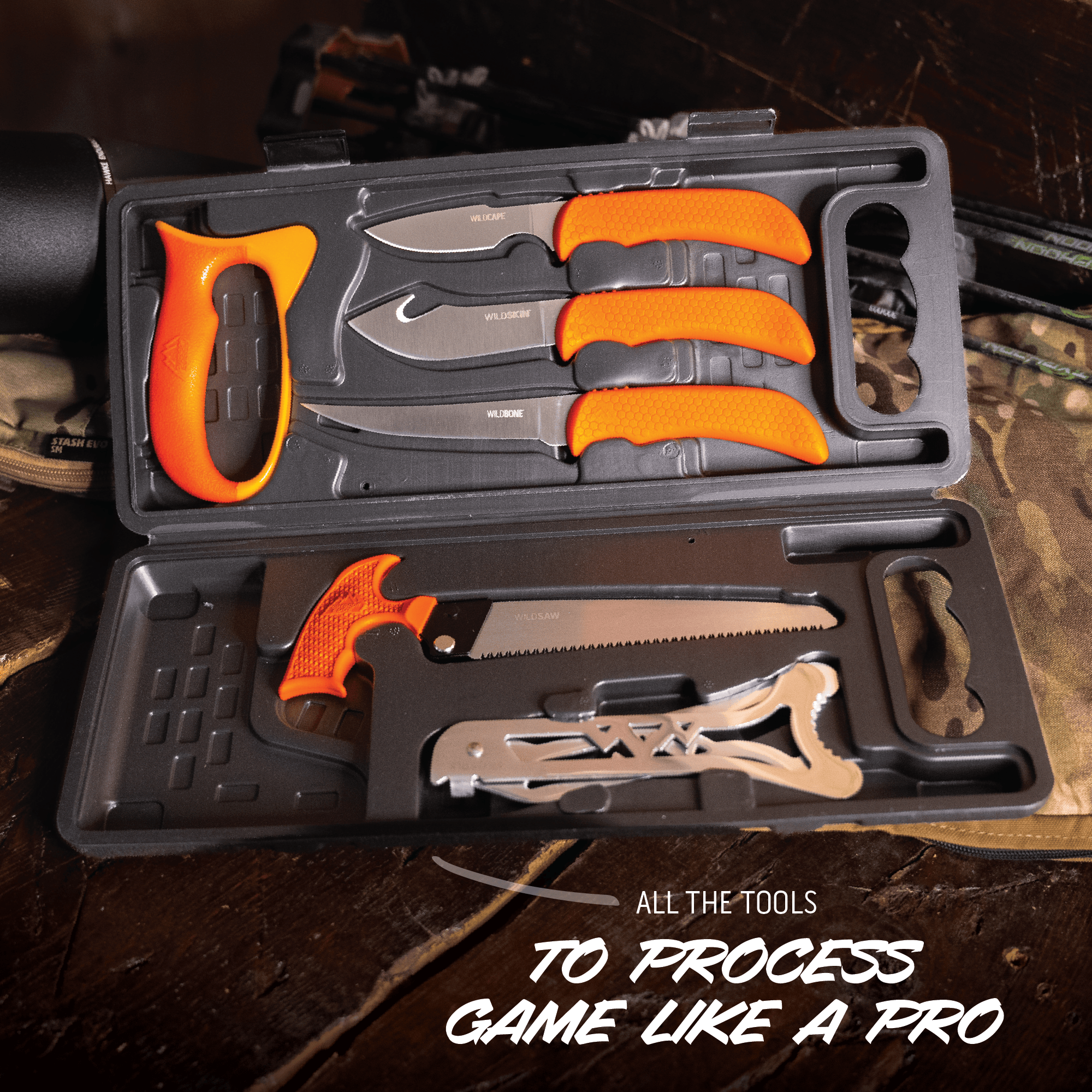 Set of hunting tools with orange handles in a case on a wooden surface.