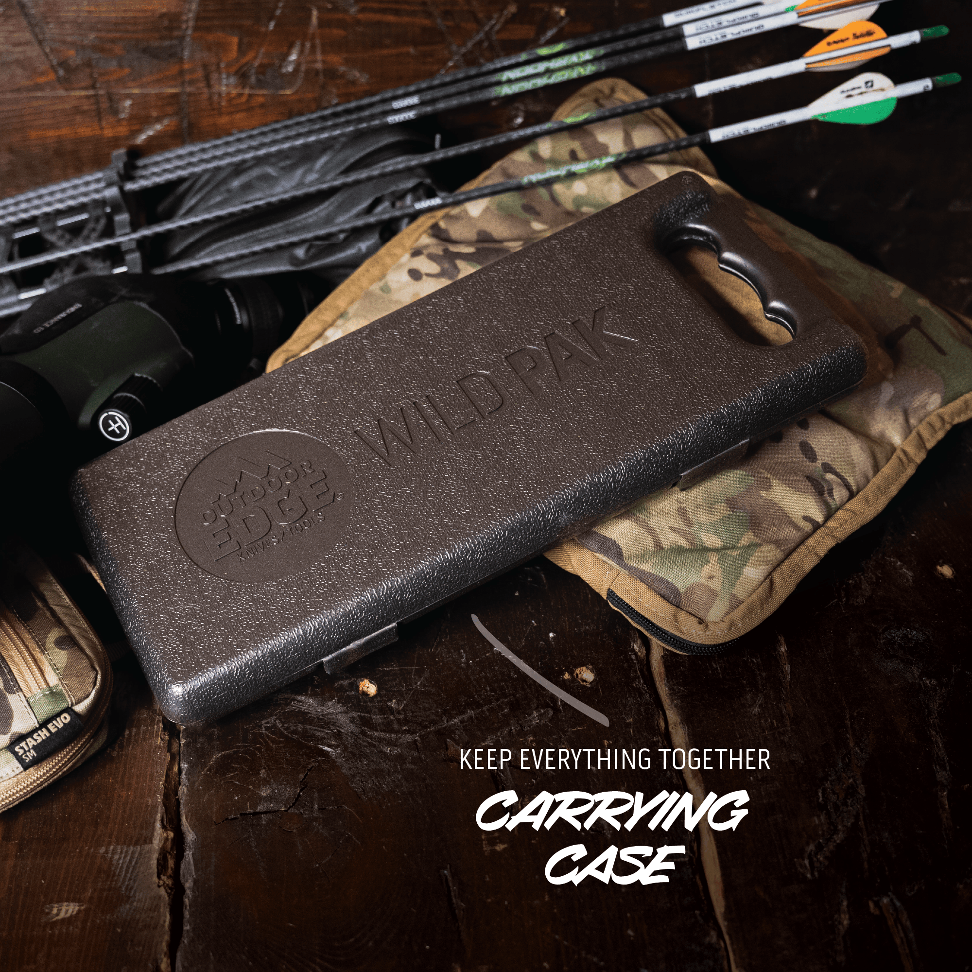 Black carrying case with 'Wild' branding on a wooden surface with archery equipment.