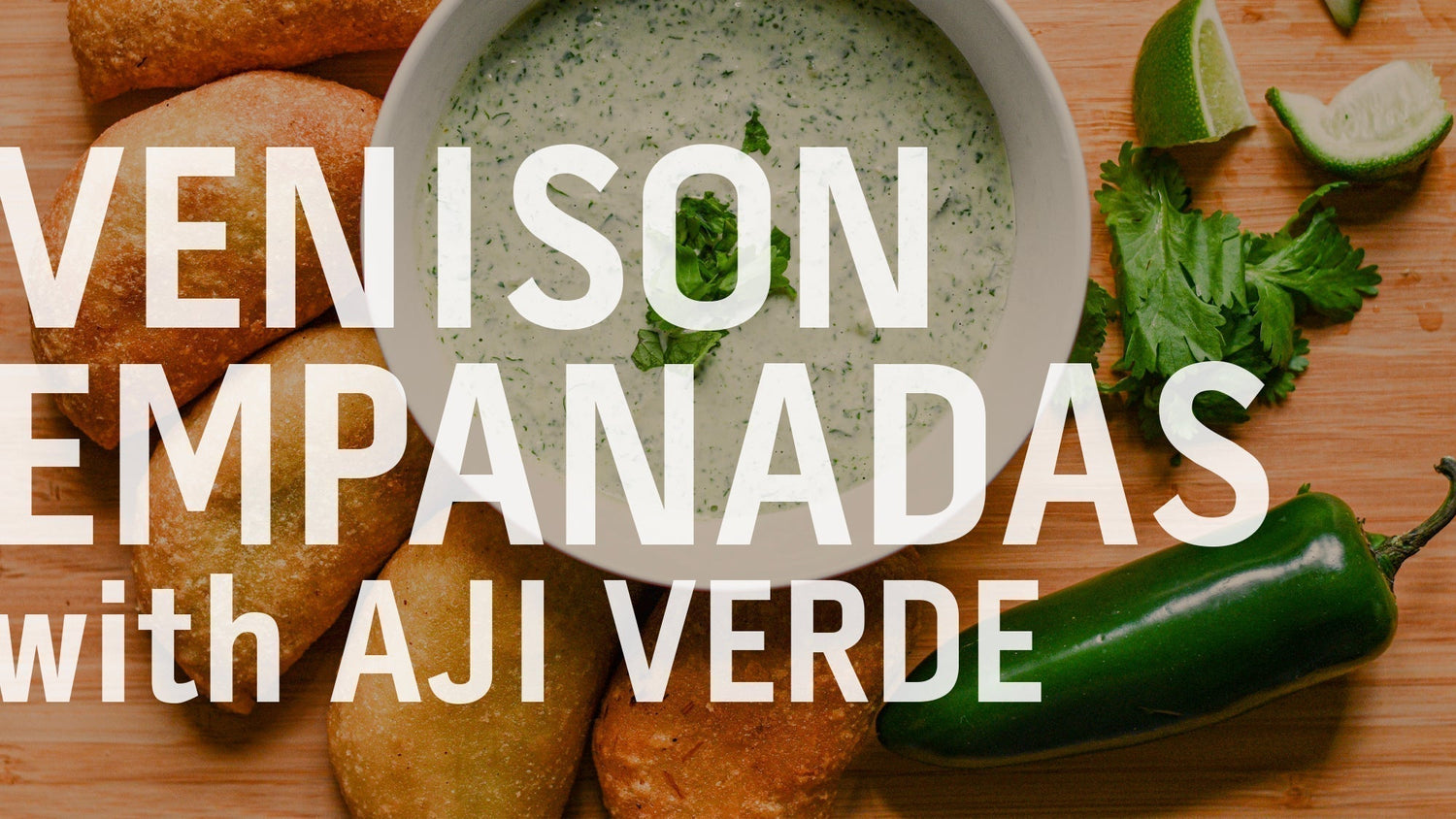A close-up of the venison empanadas served with a side of green aji verde sauce