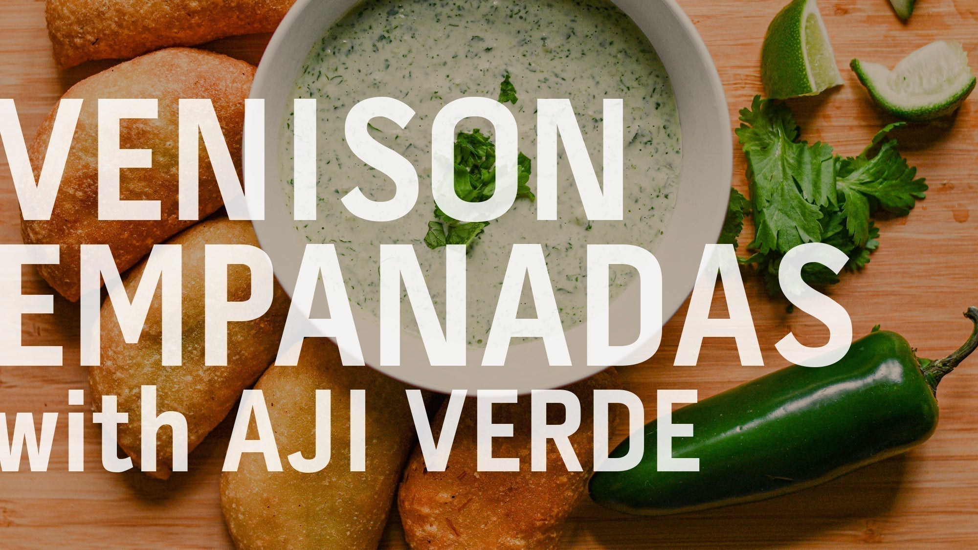A close-up of the venison empanadas served with a side of green aji verde sauce
