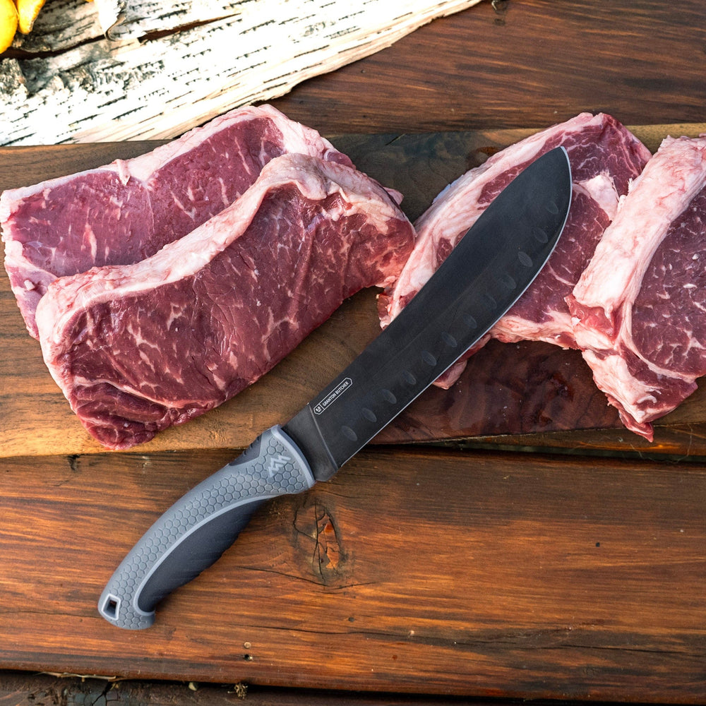 Raw steak with a large knife on a wooden surface