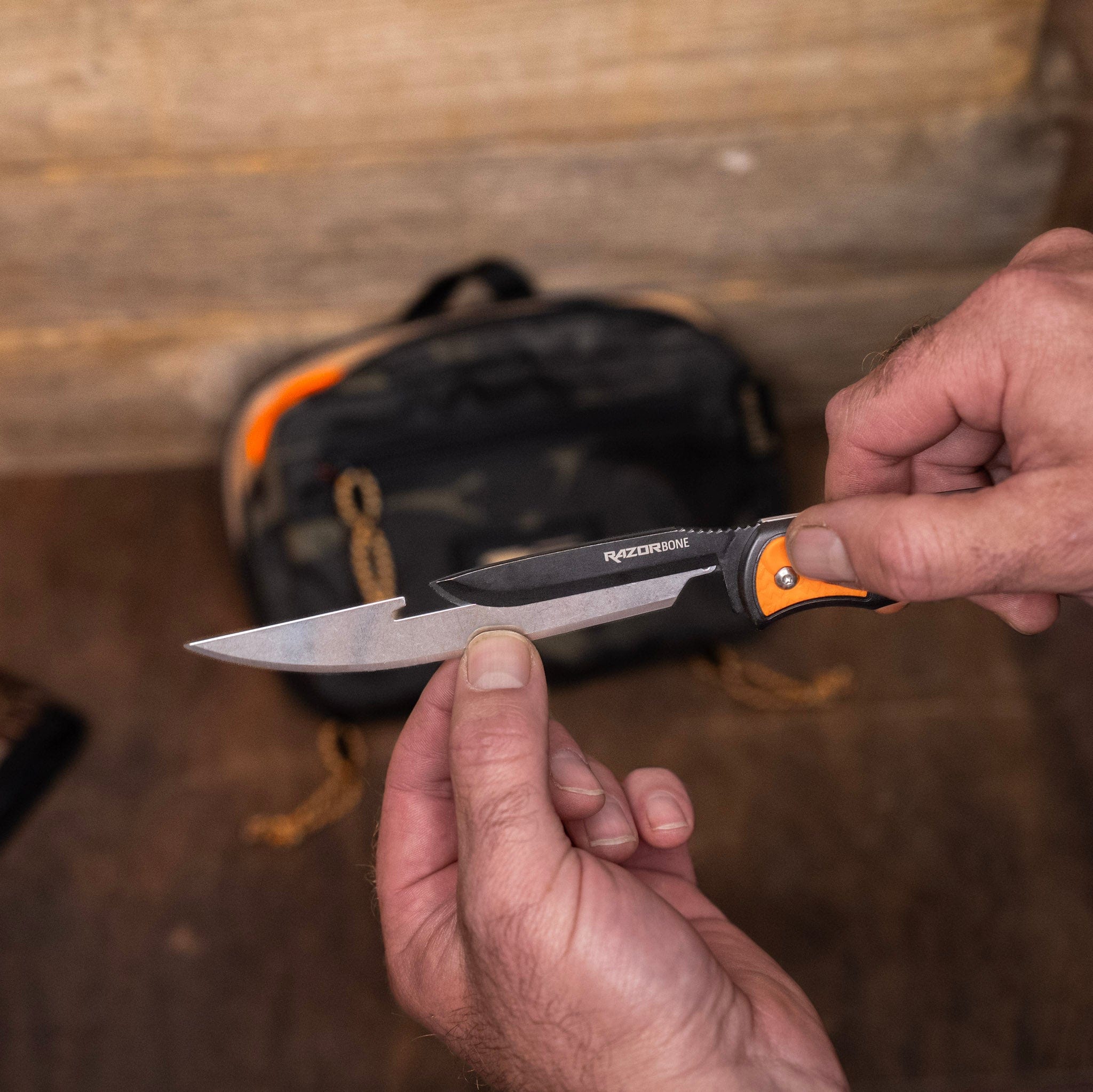 Person holding a folding knife with a blurred background