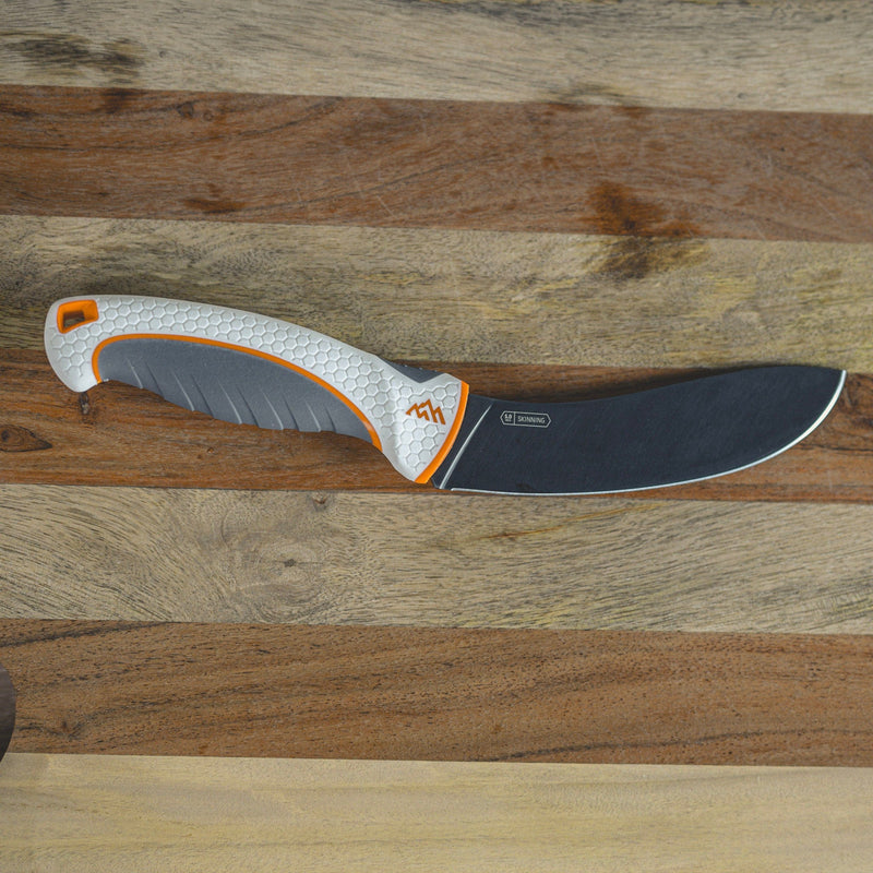 Knife with a textured handle on a wooden surface