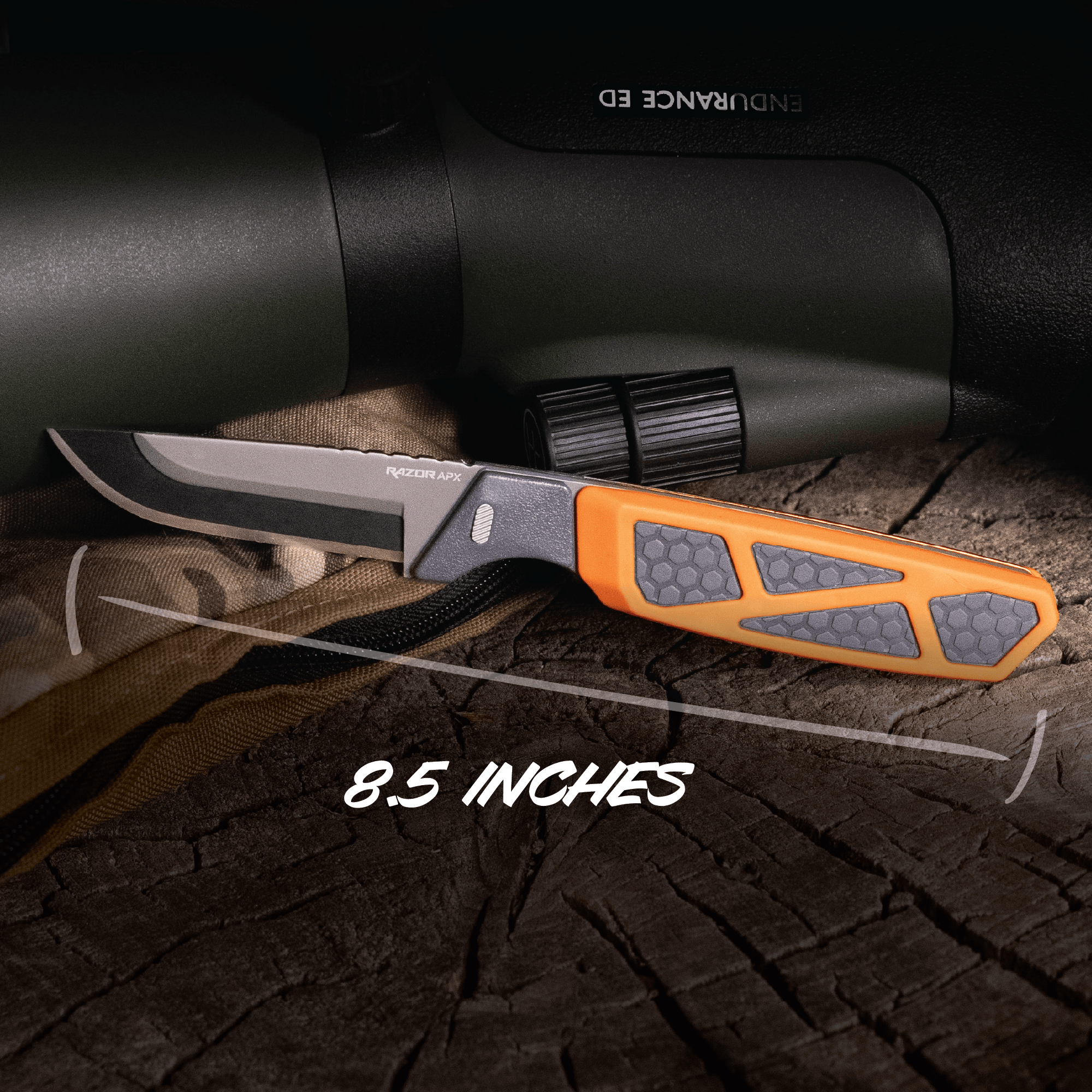 Knife with orange handle and gray blade on a wooden surface, next to a scope.