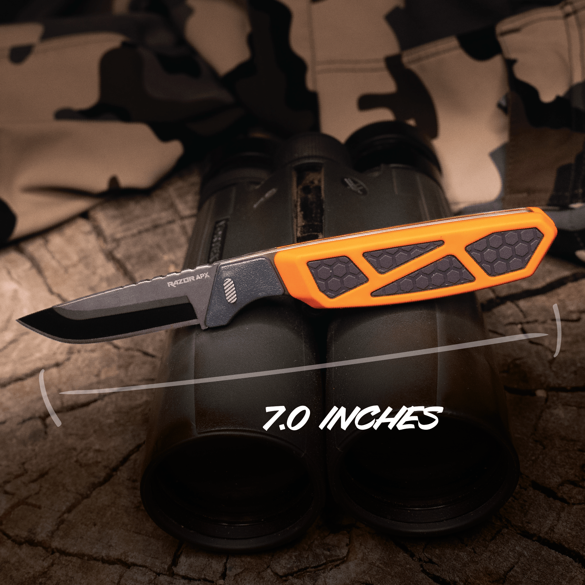 Knife with orange handle and black blade on a camouflage-patterned background, showing 7.0 inches measurement.