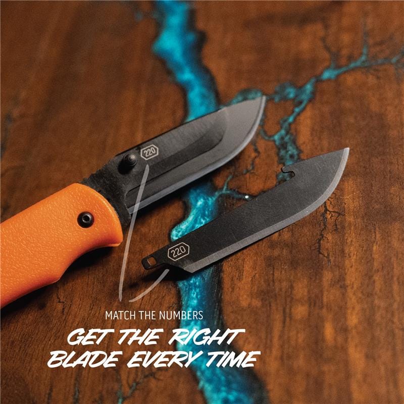 Two knives with orange and black handles on a wooden surface with blue accents.
