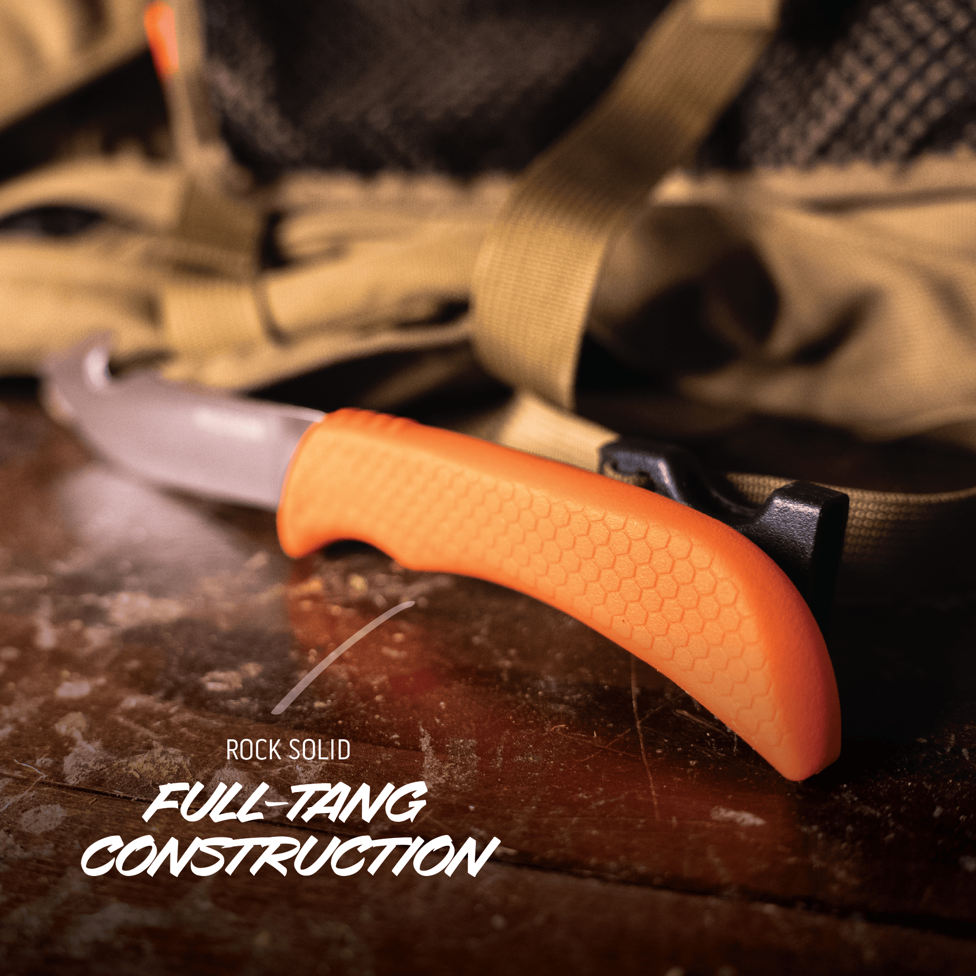 Knife with orange handle on a textured surface, featuring the text 'Rock Solid Full-Tang Construction'.