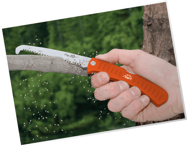 Outdoor Edge Flip n' Zip Combo Skinning Knife and Saw showing saw cutting tree.