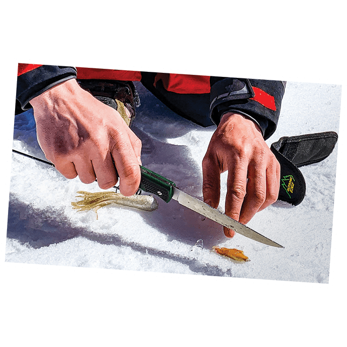 Outdoor Edge Fish and Bone Fillet Knife showing filleting fish on ice