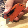 Outdoor Edge Orange SlideWinder Multi Tool cutting cardboard