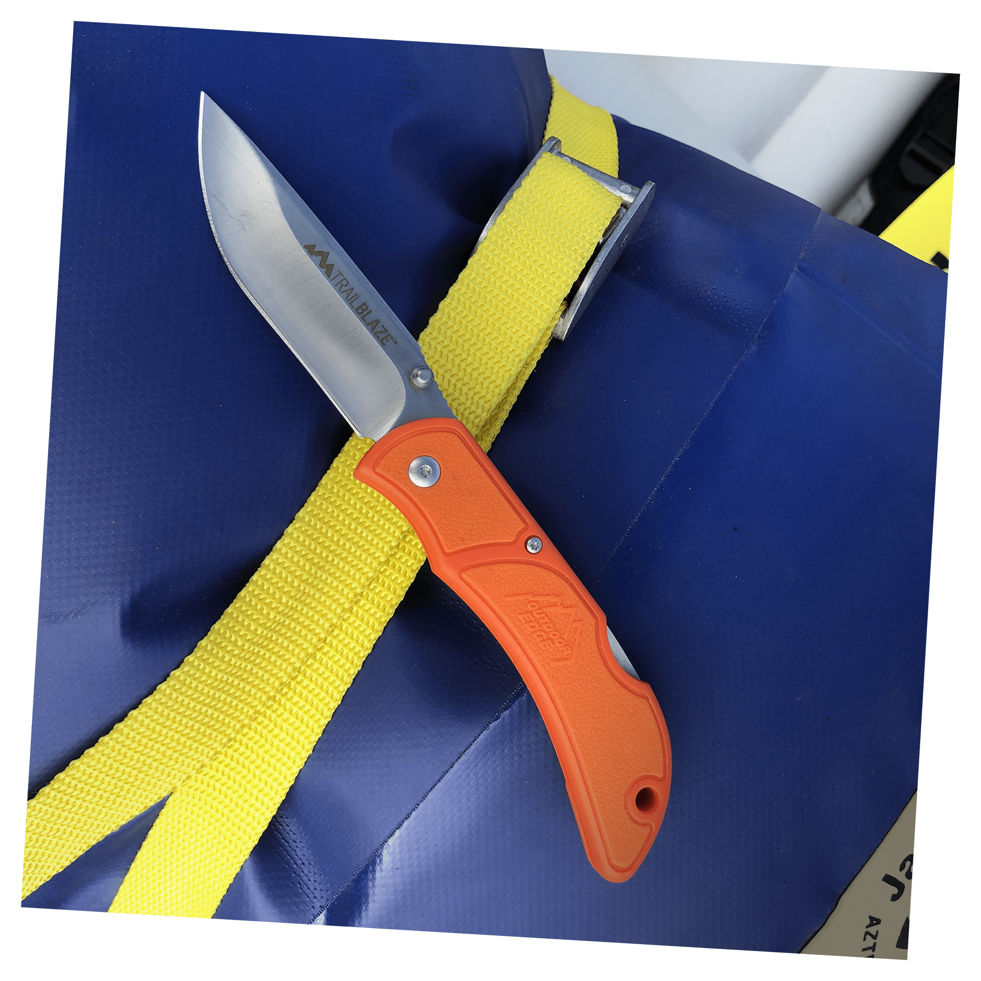 Outdoor Edge TrailBlaze best everyday carry knife displayed on a tarp